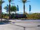 The Mountain Falls community entrance sign features a well-maintained desert landscape under a clear blue sky at 5698 Hoptree Dr # 1, Pahrump, NV 89061