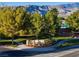 Community entrance with stone signage and lush greenery, offering a welcoming first impression at 5698 Hoptree Dr # 1, Pahrump, NV 89061