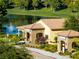 Beautiful clubhouse exterior featuring stone accents, arched entrances, and manicured landscaping at 5698 Hoptree Dr # 1, Pahrump, NV 89061