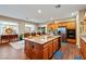 Open kitchen featuring wooden cabinets, granite countertops, and a large center island with breakfast bar at 5698 Hoptree Dr # 1, Pahrump, NV 89061