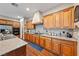 Well-lit kitchen features wood cabinets, granite countertops, and stainless steel appliances at 5698 Hoptree Dr # 1, Pahrump, NV 89061