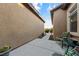 Back patio, shows stucco wall, potted plants, furniture at 5698 Hoptree Dr # 1, Pahrump, NV 89061