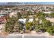 An aerial view shows the home surrounded by lush, mature trees at 5715 Gilbert Ln, Las Vegas, NV 89130