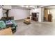 Large unfinished basement area with wood burning stove, concrete flooring, and tv at 5715 Gilbert Ln, Las Vegas, NV 89130