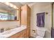 Bathroom featuring marble countertop sink and vanity, matching wooden cabinet and fixtures at 5715 Gilbert Ln, Las Vegas, NV 89130