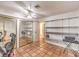 A bedroom with tile flooring, a ceiling fan, shelving units, and a large mirrored closet at 5715 Gilbert Ln, Las Vegas, NV 89130