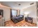 Cozy bedroom with tiled floor, a comfortable bed, desk and chair, and ample natural light at 5715 Gilbert Ln, Las Vegas, NV 89130