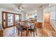 Inviting dining room with Saltillo flooring, ceiling fan, and seamless access to the kitchen at 5715 Gilbert Ln, Las Vegas, NV 89130