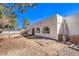 Unique home with a ladder going up to the roof and desert landscaping at 5715 Gilbert Ln, Las Vegas, NV 89130