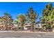 Home exterior from across street with mature trees and desert landscaping surrounding property at 5715 Gilbert Ln, Las Vegas, NV 89130