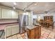 Bright kitchen featuring Saltillo tile flooring and a convenient island at 5715 Gilbert Ln, Las Vegas, NV 89130