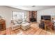 Relaxing living room area with modern furnishings, a cozy brick fireplace and tiled flooring at 5715 Gilbert Ln, Las Vegas, NV 89130