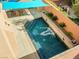 Aerial view of a backyard oasis featuring a sparkling pool, landscaping, fire bowls, and an outdoor dining area at 5971 Sonoma Station Ave, Las Vegas, NV 89139