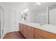 Bright bathroom with double sinks, wood cabinets, a shower and a separate toilet at 5971 Sonoma Station Ave, Las Vegas, NV 89139