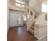 Bright foyer showcasing tile floors, staircase, and front door leading to powder room at 5971 Sonoma Station Ave, Las Vegas, NV 89139