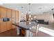 Modern kitchen with a breakfast bar island, built-in microwave, and seamless access to the living area at 5971 Sonoma Station Ave, Las Vegas, NV 89139