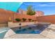 Inviting backyard pool with a modern tiled accent, water features, and a desert landscape at 5971 Sonoma Station Ave, Las Vegas, NV 89139