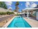 Backyard oasis featuring a pool, covered patio and lush landscaping creates a serene outdoor living space at 6109 Flaming Arrow Rd, North Las Vegas, NV 89031