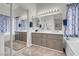 A large, modern bathroom featuring a double sink vanity and a large mirror at 6109 Flaming Arrow Rd, North Las Vegas, NV 89031