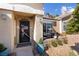 Charming entryway featuring desert landscaping, a covered porch, and a decorative security door at 6109 Flaming Arrow Rd, North Las Vegas, NV 89031