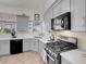 Modern kitchen with gray cabinets, stainless steel appliances, and bright natural light at 6109 Flaming Arrow Rd, North Las Vegas, NV 89031