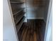 Walk-in closet featuring wooden shelving and laminate wood flooring providing ample storage solutions at 615 S Royal Crest Cir # 15, Las Vegas, NV 89169