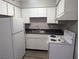 A compact kitchen featuring white appliances and cabinets at 615 S Royal Crest Cir # 15, Las Vegas, NV 89169