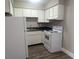 Cozy kitchen with white cabinets and appliances, and dark countertops at 615 S Royal Crest Cir # 15, Las Vegas, NV 89169