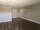 An empty living room featuring modern wood-look floors and freshly painted walls at 615 S Royal Crest Cir # 15, Las Vegas, NV 89169