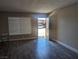 Living room with wood-look floors, bright windows with blinds, and neutral paint at 615 S Royal Crest Cir # 15, Las Vegas, NV 89169