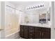 Bathroom featuring double sink vanity and a tub with shower at 6314 Ruby Cedar Ct, North Las Vegas, NV 89031