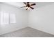 Neutral bedroom with a ceiling fan, a window with blinds, and carpeted floors at 6314 Ruby Cedar Ct, North Las Vegas, NV 89031