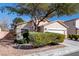 Charming single-story home with a well-manicured front yard and attached two-car garage at 6314 Ruby Cedar Ct, North Las Vegas, NV 89031