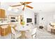 Open-concept dining area with marble table, seating for four, and views of the kitchen at 6653 Lund Dr, Las Vegas, NV 89108