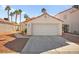 Charming single-story home featuring a two-car garage, desert landscaping, and a red tile roof at 6653 Lund Dr, Las Vegas, NV 89108