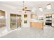 Bright kitchen features tile floors, a ceiling fan, and a breakfast bar at 6653 Lund Dr, Las Vegas, NV 89108