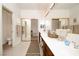 Bright bathroom featuring double sinks, neutral tile, and a large mirror creating an open space at 692 Quilt Pl, Henderson, NV 89052