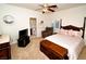 Cozy bedroom with neutral tones, plantation shutters, ceiling fan and ensuite bathroom at 692 Quilt Pl, Henderson, NV 89052