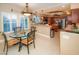 Charming breakfast nook with glass top table near the kitchen and windows at 692 Quilt Pl, Henderson, NV 89052