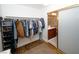 Spacious walk-in closet featuring hanging storage and view to vanity area at 692 Quilt Pl, Henderson, NV 89052