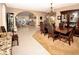 Elegant dining room featuring tile floors, an ornate chandelier, and a wooden table at 692 Quilt Pl, Henderson, NV 89052