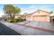 Charming single-story home with a three-car garage and well-maintained landscaping at 692 Quilt Pl, Henderson, NV 89052