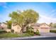 Charming single-story home with a tile roof, lush lawn, mature landscaping, and a spacious three-car garage at 692 Quilt Pl, Henderson, NV 89052