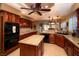 Beautiful kitchen with cherry wood cabinets, granite countertops, tile floor and stainless steel appliances at 692 Quilt Pl, Henderson, NV 89052