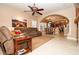 Comfortable living room with tile floors, an arched doorway, and a ceiling fan at 692 Quilt Pl, Henderson, NV 89052