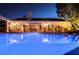 Night view of a private backyard pool reflecting the house lights in the clear, blue water at 692 Quilt Pl, Henderson, NV 89052