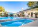 A gorgeous backyard pool and spa with a covered patio creates a resort-like feel for relaxation and entertainment at 692 Quilt Pl, Henderson, NV 89052