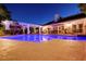 An in-ground pool is surrounded by a concrete patio and accented by manicured tropical landscaping at 692 Quilt Pl, Henderson, NV 89052