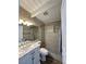 Bathroom featuring a vanity with marble countertop, tiled walls, and a shower with blue stone floor at 712 Harvard St, Las Vegas, NV 89107