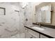 Modern bathroom with marble tile shower and gray countertop vanity, offering a sleek and stylish design at 7229 Mira Vista St, Las Vegas, NV 89120